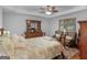 Inviting main bedroom featuring tray ceiling, decorative furniture, and cozy sitting area at 50 Ridgeview Dr, Jonesboro, GA 30236