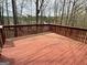 Spacious stained wooden deck, surrounded by trees, offering a private outdoor living space with natural views at 602 Springharbor Dr, Woodstock, GA 30188