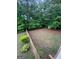 Large fenced backyard featuring mature trees and green space providing a private outdoor setting at 22 Shea Ct, Douglasville, GA 30134