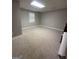 Spacious finished basement with neutral walls, carpet flooring and a window at 22 Shea Ct, Douglasville, GA 30134