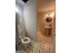Full bathroom with patterned tile, pedestal sink, shower, and round mirror at 22 Shea Ct, Douglasville, GA 30134