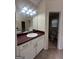 Neutral toned bathroom featuring a single sink vanity with a dark countertop at 22 Shea Ct, Douglasville, GA 30134