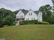 Traditional white home with lush greenery providing a serene and private setting at 22 Shea Ct, Douglasville, GA 30134
