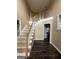 Bright foyer with wood floors, an elegant staircase, and access to multiple rooms, creating an inviting entrance at 22 Shea Ct, Douglasville, GA 30134
