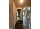 Hallway view with hardwood flooring leading to various rooms in the house, showcasing the home's layout at 22 Shea Ct, Douglasville, GA 30134
