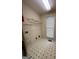 Functional laundry room featuring white appliances, wire shelving, and a window for natural light at 22 Shea Ct, Douglasville, GA 30134