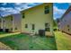 View of the backyard featuring a simple lawn and the home's exterior, door and windows at 11224 Aliyah Dr, Hampton, GA 30228