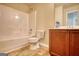 Well-lit bathroom with a tub/shower combo, wood vanity, and neutral flooring at 11224 Aliyah Dr, Hampton, GA 30228