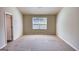 Bright bedroom with large window, neutral walls, and plush carpet flooring at 11224 Aliyah Dr, Hampton, GA 30228