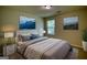 Cozy bedroom features calming paint, neutral décor, and a large window, creating a peaceful retreat at 11224 Aliyah Dr, Hampton, GA 30228