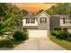 Charming two-story home boasts a combination of light beige siding and gray brick, and a two-car garage at 11224 Aliyah Dr, Hampton, GA 30228