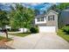 Charming two-story home boasts a combination of light beige siding and gray brick, and a two-car garage at 11224 Aliyah Dr, Hampton, GA 30228