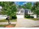 Charming two-story home boasts a combination of light beige siding and gray brick, and a two-car garage at 11224 Aliyah Dr, Hampton, GA 30228