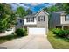 Charming two-story home boasts a combination of light beige siding and gray brick, and a two-car garage at 11224 Aliyah Dr, Hampton, GA 30228