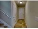 Hallway leading to a front door, with tile flooring and a staircase nearby at 11224 Aliyah Dr, Hampton, GA 30228