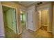 Upstairs hallway featuring several doors to carpeted and tiled rooms at 11224 Aliyah Dr, Hampton, GA 30228