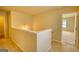 Hallway with a landing leads to carpeted rooms and natural light at 11224 Aliyah Dr, Hampton, GA 30228