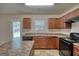 Bright kitchen featuring stone-look countertops, wood cabinets, and modern appliances at 11224 Aliyah Dr, Hampton, GA 30228