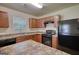 Well-equipped kitchen with black appliances, ample counter space, and light wood cabinetry at 11224 Aliyah Dr, Hampton, GA 30228