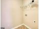 Bright laundry room featuring durable flooring, wire shelving, and utility connections at 11224 Aliyah Dr, Hampton, GA 30228