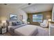 Comfortable main bedroom boasts a large bed, ample natural light, and a serene atmosphere, perfect for relaxation at 11224 Aliyah Dr, Hampton, GA 30228