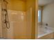 Bathroom featuring both a shower and a tub with a window for natural light at 11224 Aliyah Dr, Hampton, GA 30228