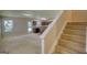 Staircase leading to upper levels, next to the open living and kitchen area at 11224 Aliyah Dr, Hampton, GA 30228
