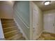 Carpeted staircase and view of the entry and closet, leading to upper levels at 11224 Aliyah Dr, Hampton, GA 30228
