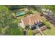 Aerial view of a charming two-story home with manicured lawn, mature trees, a pool, and guesthouse at 105 Suffolk Pl, Fayetteville, GA 30215