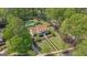 Aerial view of a charming two-story home with manicured lawn, mature trees, a pool, and guesthouse at 105 Suffolk Pl, Fayetteville, GA 30215