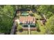 Aerial view of a charming two-story home with manicured lawn, mature trees, a pool, and guesthouse at 105 Suffolk Pl, Fayetteville, GA 30215