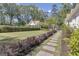 View of a professionally landscaped backyard with stone pathway and guesthouse at 105 Suffolk Pl, Fayetteville, GA 30215