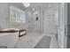 Luxurious bathroom with a soaking tub, walk-in shower, marble tile, and elegant chandelier at 105 Suffolk Pl, Fayetteville, GA 30215