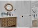 Charming powder room features wooden vanity, marble top, and decorative mirror at 105 Suffolk Pl, Fayetteville, GA 30215