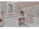 Chic bathroom with patterned wallpaper, a marble vanity, and ornate mirror at 105 Suffolk Pl, Fayetteville, GA 30215