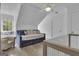 Bright bedroom features a daybed, crib, window seat, and hardwood floors at 105 Suffolk Pl, Fayetteville, GA 30215