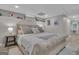 A bedroom with a beige upholstered bed frame, light wood floors and neutral colored walls at 105 Suffolk Pl, Fayetteville, GA 30215