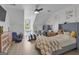 Stylish bedroom with blue accents, hardwood floors, and a cozy window nook at 105 Suffolk Pl, Fayetteville, GA 30215