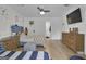 Bright bedroom with white walls, hard wood floors, blue accents and a mounted TV at 105 Suffolk Pl, Fayetteville, GA 30215