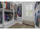 Walk-in closet with custom shelving, built-in drawers, and window at 105 Suffolk Pl, Fayetteville, GA 30215