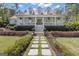 Inviting two-story home with a charming front porch and beautiful landscaped walkway at 105 Suffolk Pl, Fayetteville, GA 30215