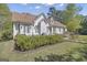 Expansive backyard showcasing manicured lawns, mature trees, and the home's exterior at 105 Suffolk Pl, Fayetteville, GA 30215