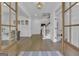 Bright foyer with hardwood floors, wooden framed glass paneled doors, and elegant decor at 105 Suffolk Pl, Fayetteville, GA 30215