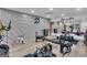 Brightly lit home gym featuring hardwood floors and multiple pieces of fitness equipment at 105 Suffolk Pl, Fayetteville, GA 30215