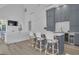 Open concept kitchen with stylish gray cabinets, a large island with seating, and modern appliances at 105 Suffolk Pl, Fayetteville, GA 30215