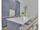 A stunning kitchen island featuring gray cabinetry, a white countertop, and a stylish seating area at 105 Suffolk Pl, Fayetteville, GA 30215
