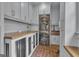 Well-equipped laundry room with brick floors, stacked washer/dryer and dog kennels at 105 Suffolk Pl, Fayetteville, GA 30215