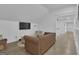 Bright living room boasts hardwood floors, a leather sofa, and a wall-mounted TV at 105 Suffolk Pl, Fayetteville, GA 30215
