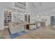 Open-concept living room with built-in bookshelves, fireplace, and views into the gourmet kitchen at 105 Suffolk Pl, Fayetteville, GA 30215