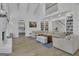 Open-concept living room with fireplace, built-in shelving and stairs to the upper level at 105 Suffolk Pl, Fayetteville, GA 30215